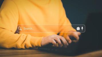 freelance-s-hand-working-with-computer-laptop-on-desk-in-home-searching-browsing-internet-data-information-with-blank-search-bar-search-engine-optimization-seo-networking-concept-photo